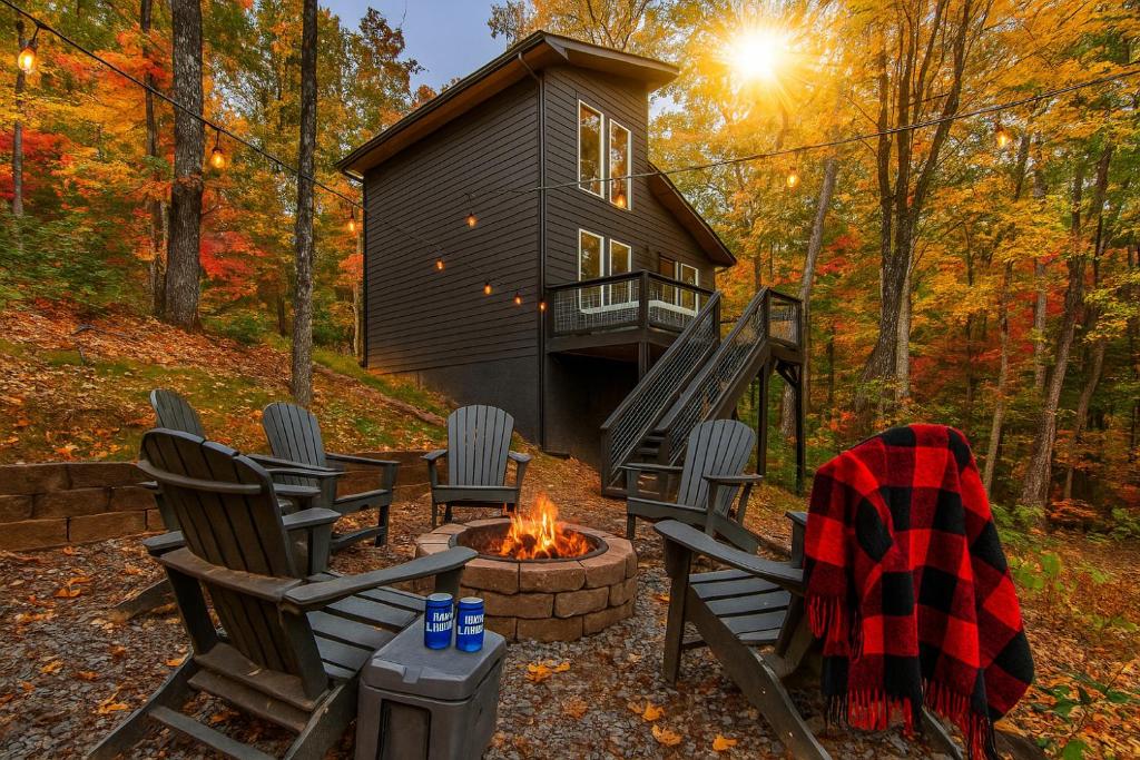 a cabin in the woods with chairs and a fire pit at Hot Tub, Games, Fireplace & Fast WiFi Near Dollywood in Sevierville