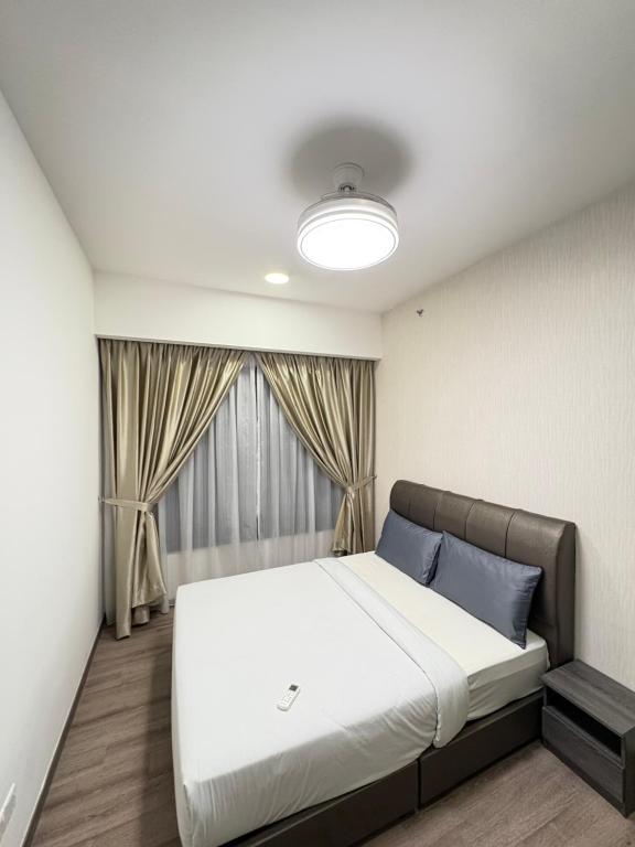 a bedroom with a large bed in front of a window at Klcc suite by Agile Residence in Kuala Lumpur