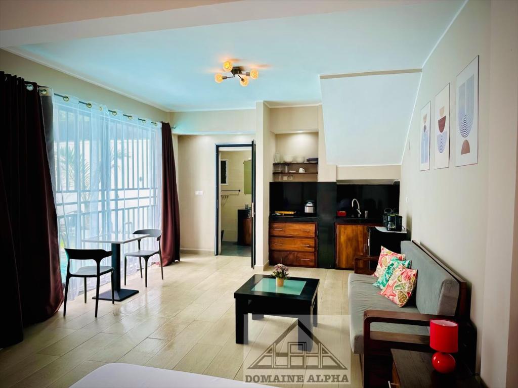 a living room with a couch and a table at Domaine Alpha in Toamasina