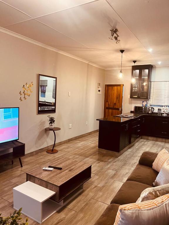 a living room with a couch and a flat screen tv at Mama R's unit 39 in Newcastle