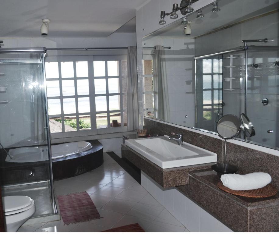 ein Badezimmer mit Waschbecken, Dusche und Badewanne in der Unterkunft Pousada Chic N Choc in Morro de São Paulo