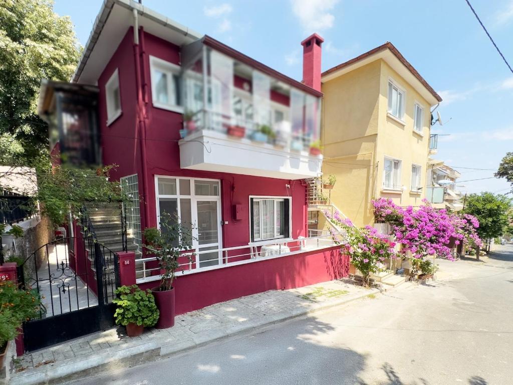 a red house with flowers in front of it at Garden House Heybeliada in Adalar