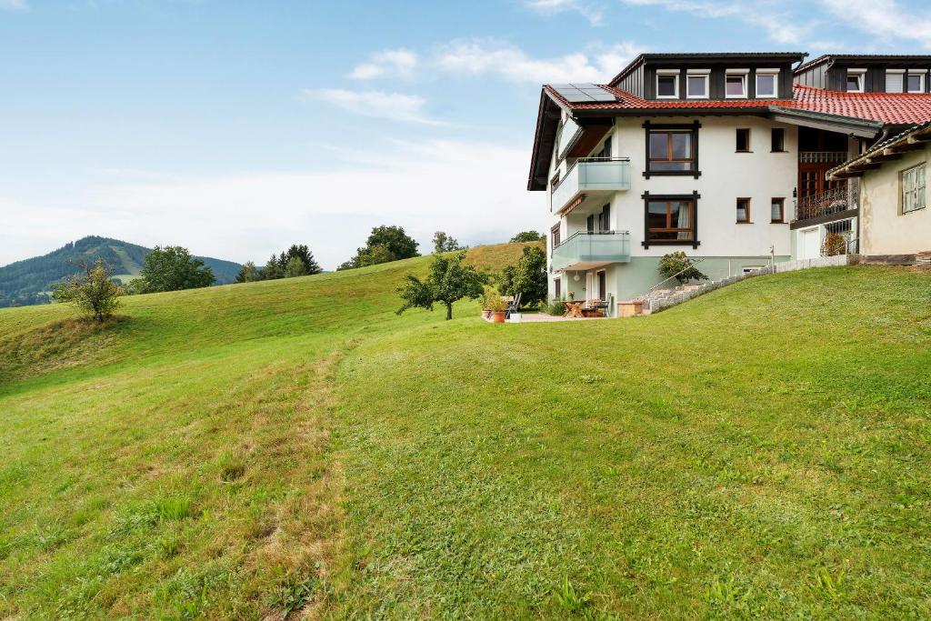 a house on a hill with a green field at Fewo Weitblick - Haus Sommerberg in Baiersbronn