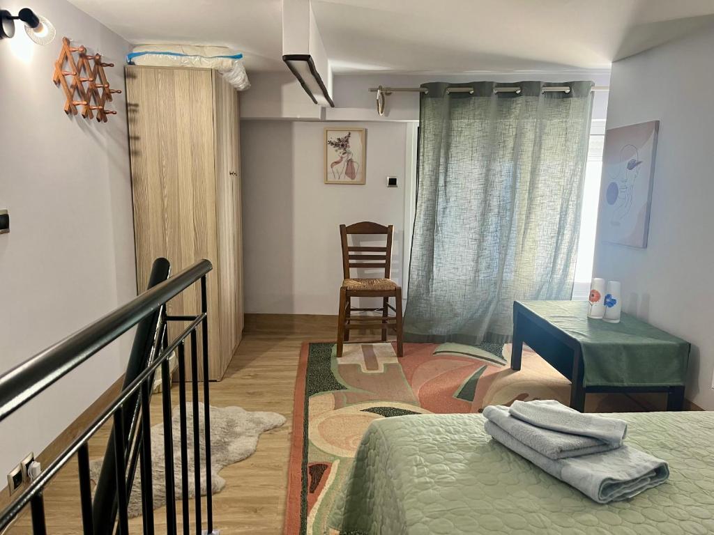 a room with a bed and a table and a chair at Chic & Cozy Apartment in Gazi, Athens in Athens