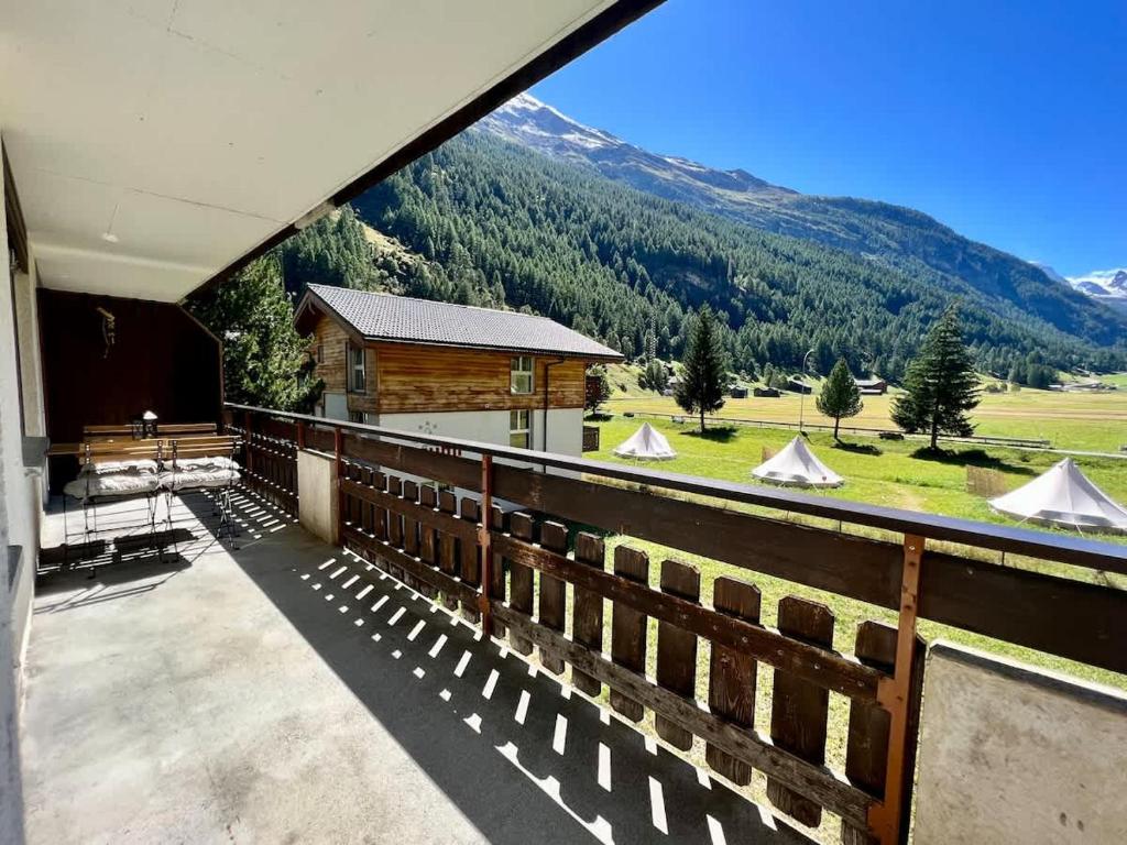 a balcony of a house with a view of a mountain at Mountain magic apartment for 6 Near Zermatt with parking! in Täsch