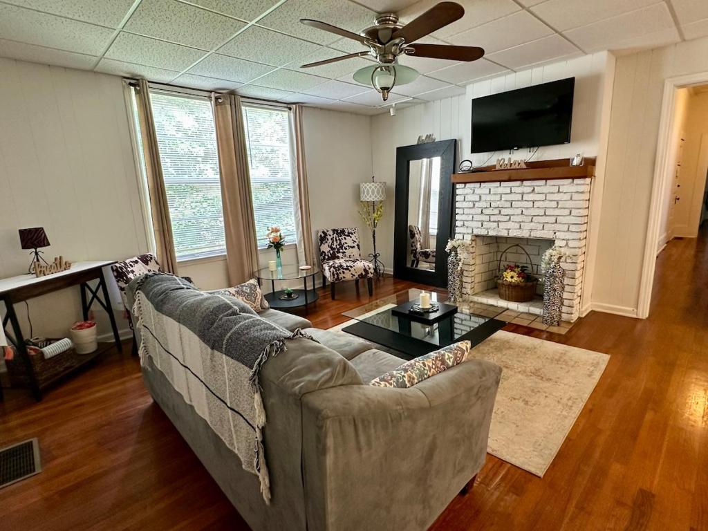 a living room with a couch and a fireplace at Hannah House South Cozy country living near the city in Thomaston