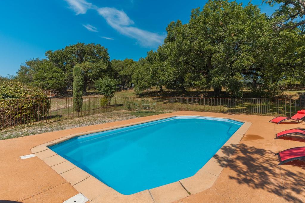 a blue swimming pool on a patio at Bastide Provençale in Caseneuve
