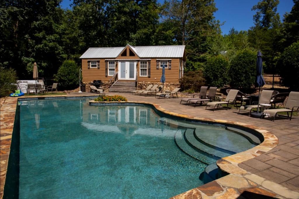 a log cabin with a swimming pool and a tiny house at Cricket by the Creek - Creek, Gym, Trails, Kayaks in Menlo