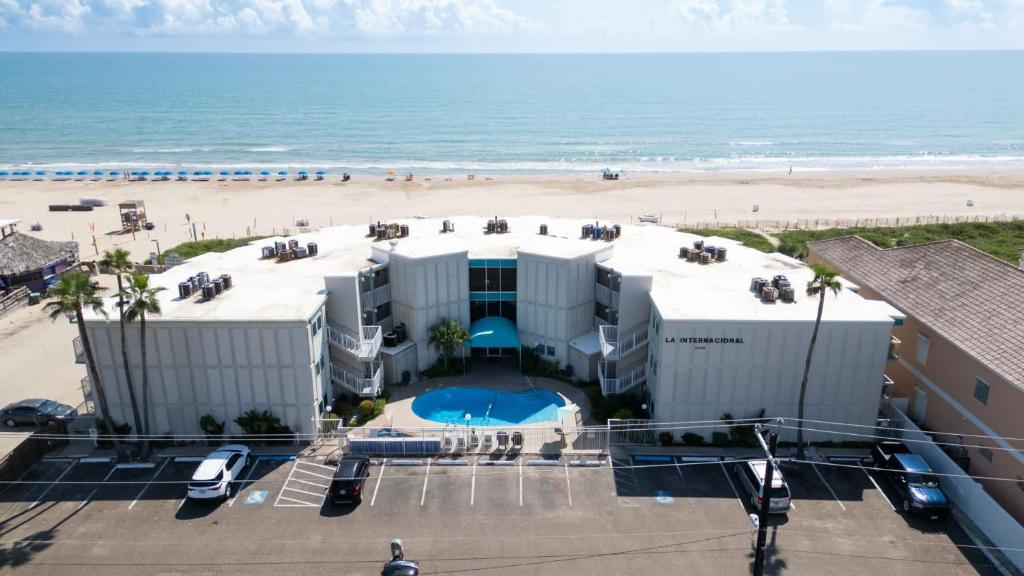 a large white building next to a beach at La Internacional 313 home in South Padre Island