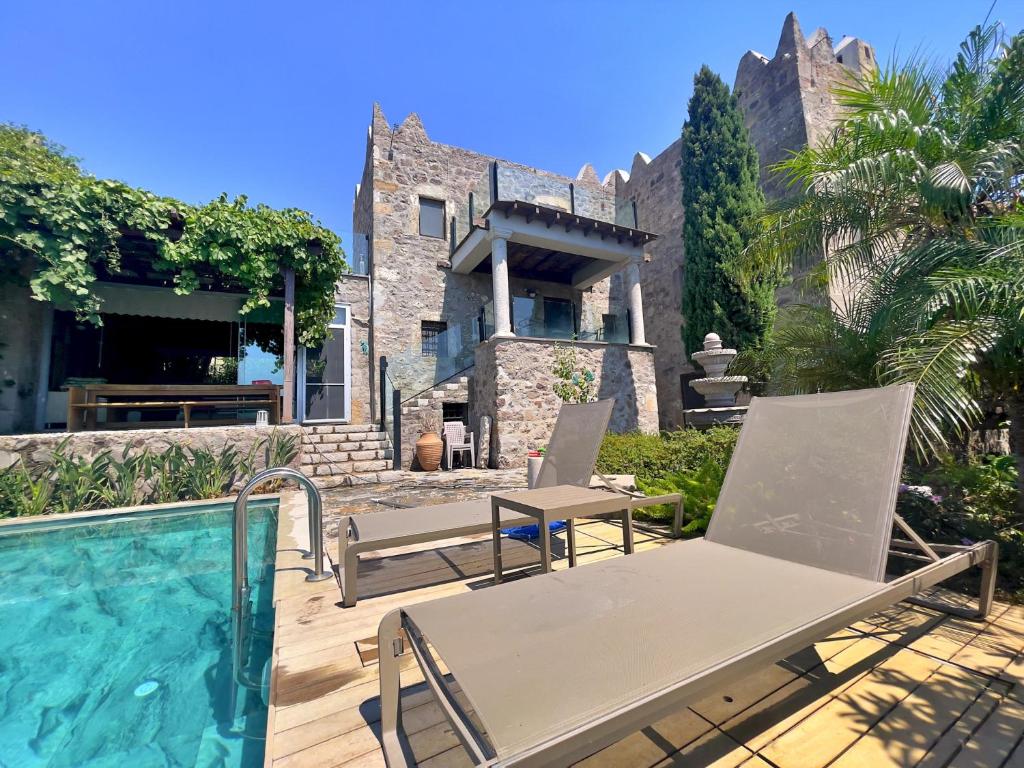 a house with a swimming pool next to a building at Private Pool Getaway in a Luxury Stone Villa in Bodrum City