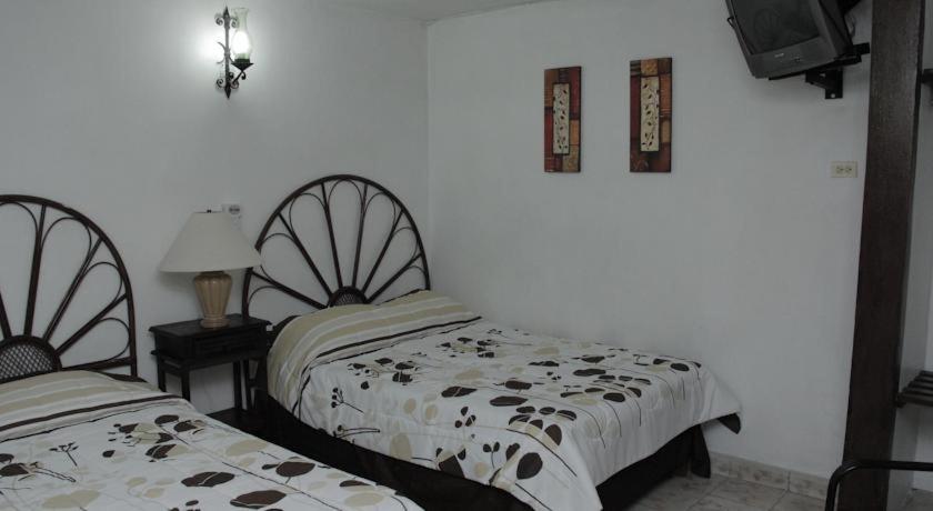 Postel nebo postele na pokoji v ubytování Hotel Posada del Angel