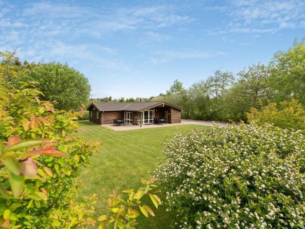 a house in the middle of a yard at Holiday Home Els - 900m from the sea by Interhome in Fjerritslev