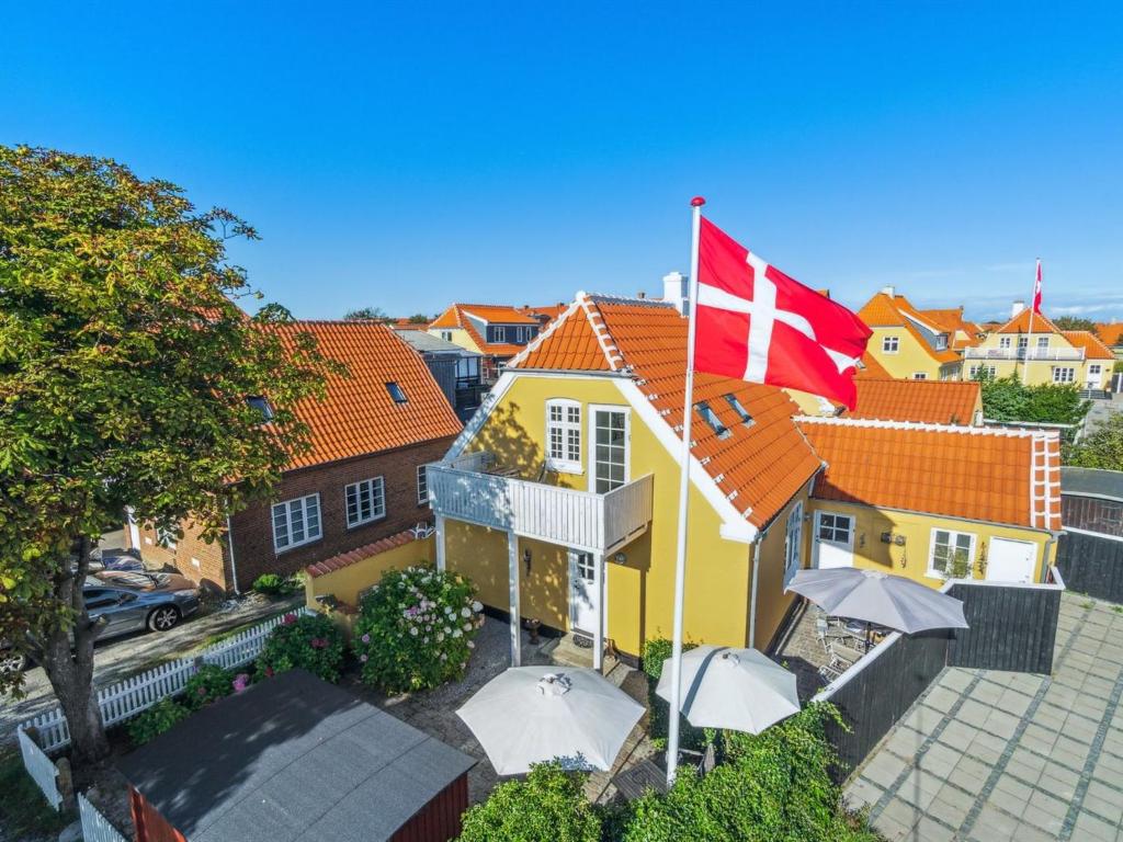 a house with a swiss flag on top of it at Holiday Home Ortrud - 200m from the sea by Interhome in Skagen