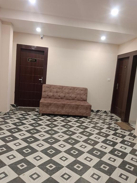 a waiting room with a couch in front of a door at Shanti Meridian in Jāmb