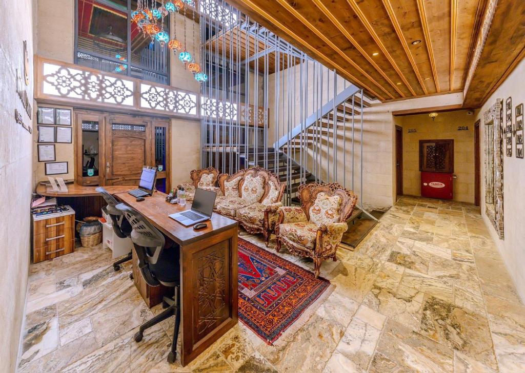 a room with a desk and chairs in a building at Noble Crown Stone House Cappadocia in Uchisar