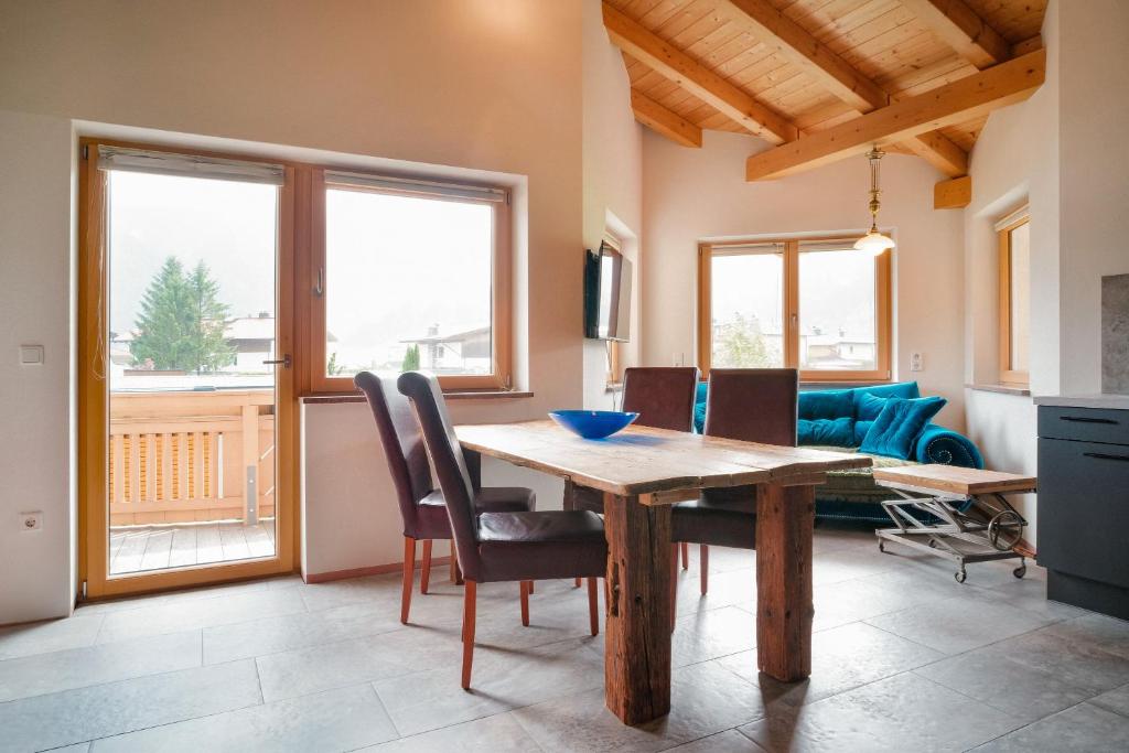 a dining room with a wooden table and chairs at Appartement Resi in Achensee