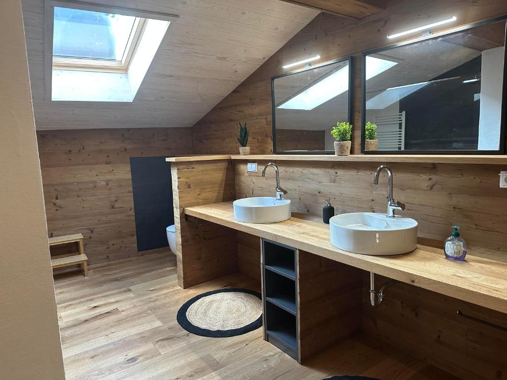 a bathroom with two sinks and a mirror at Fritz Alpchalets - Haus Lechtal in Vorderhornbach