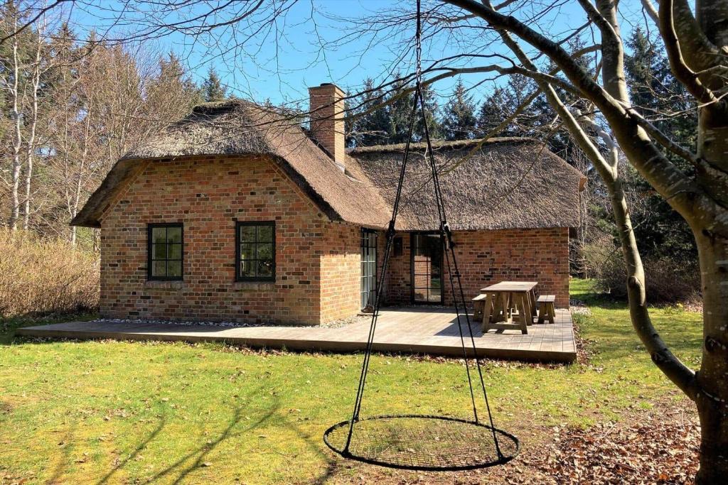 a brick house with a swing in front of it at 10149-Ulfborg-Svollingvej-7 in Øhuse