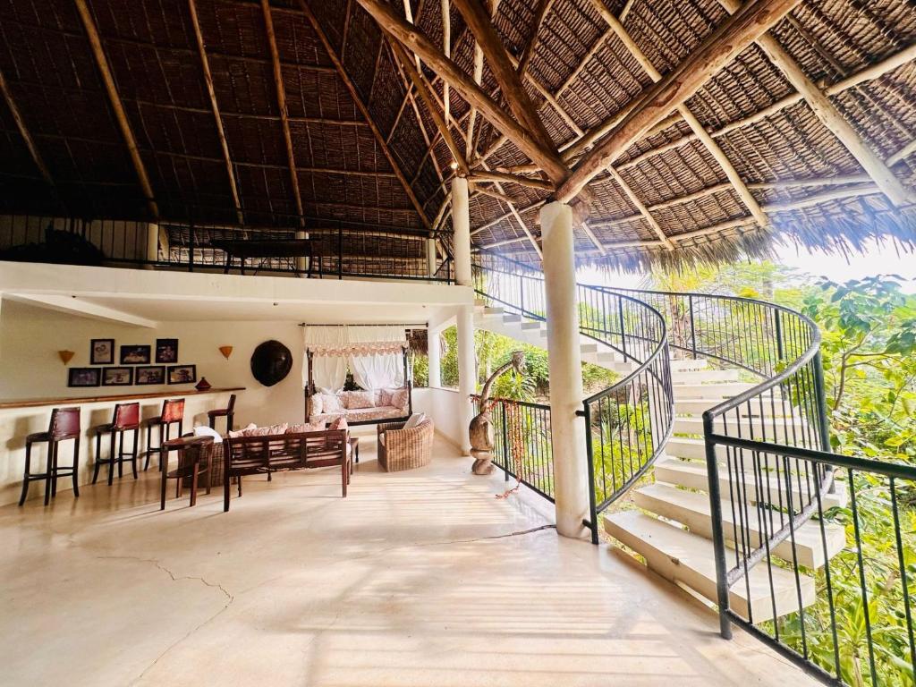 a living room with a balcony and a dining room at Jawpan's place in Malindi