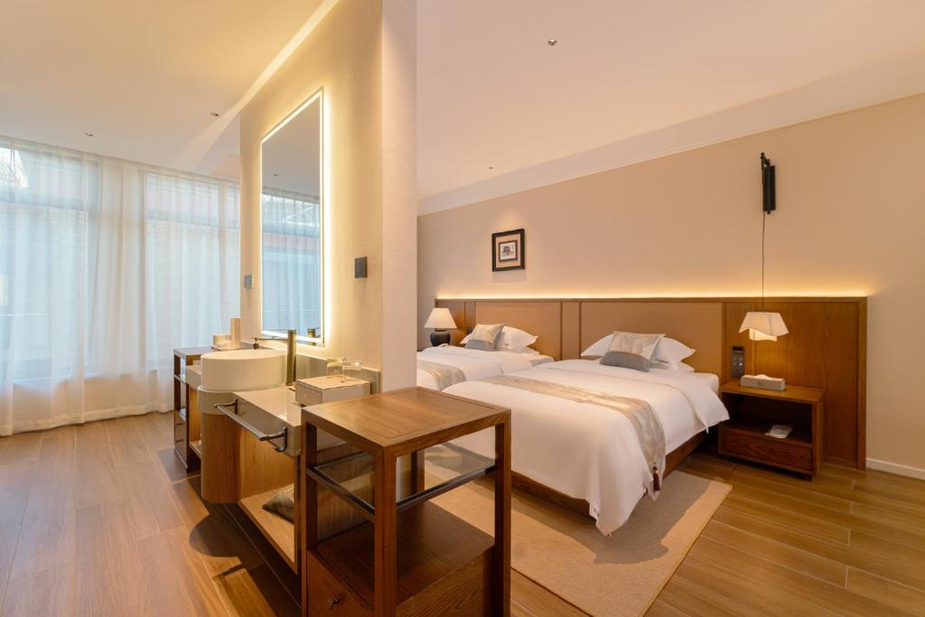Postel nebo postele na pokoji v ubytování Liao Liao Xin Yuan Boutique Hotel