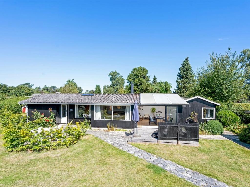 a home with a garden and a house at Holiday Home Keke - 120m from the sea by Interhome in Rødvig