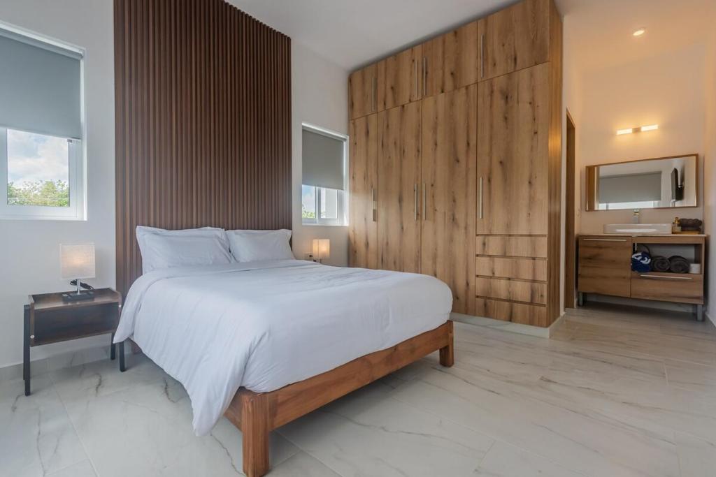 una camera da letto con un letto grande con una parete in legno di Malibu Residential 3BD - Lia a Cozumel
