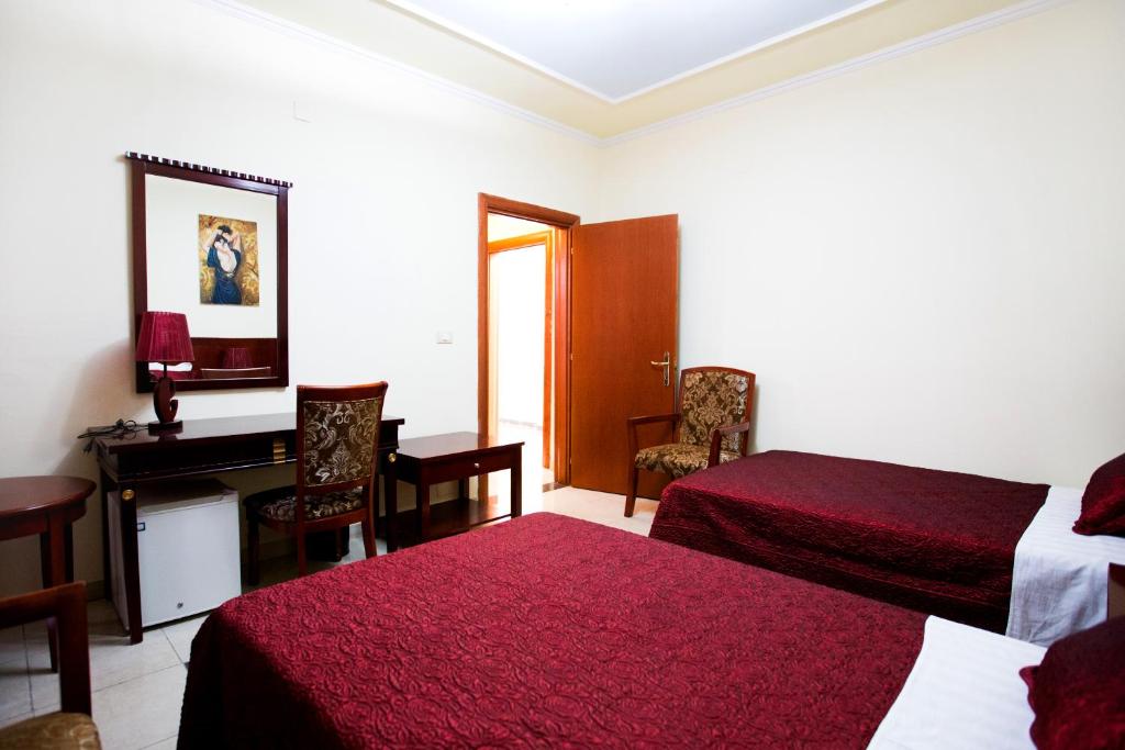 Postel nebo postele na pokoji v ubytování Orchidea Hotel