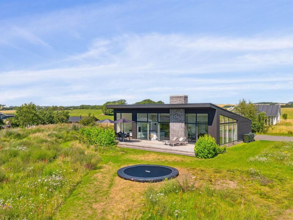 a small house with a gambrel roof at Holiday Home Bæver - 200m from the sea by Interhome in Knebel