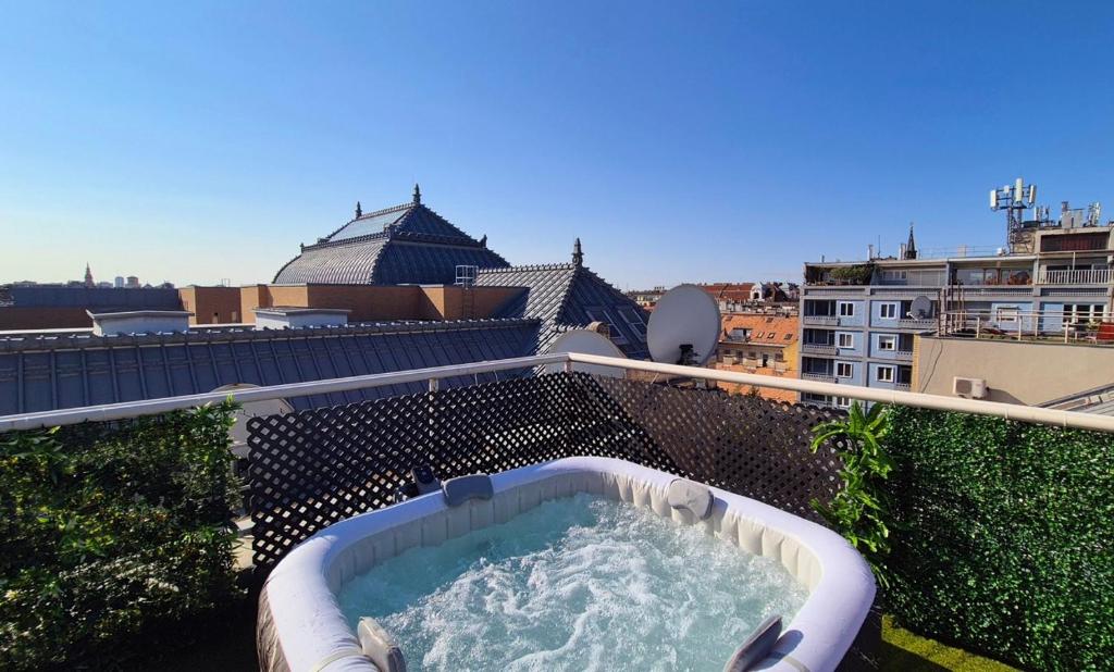 a hot tub on the roof of a building at Budapest Central Sky Spa Penthouse in Budapest
