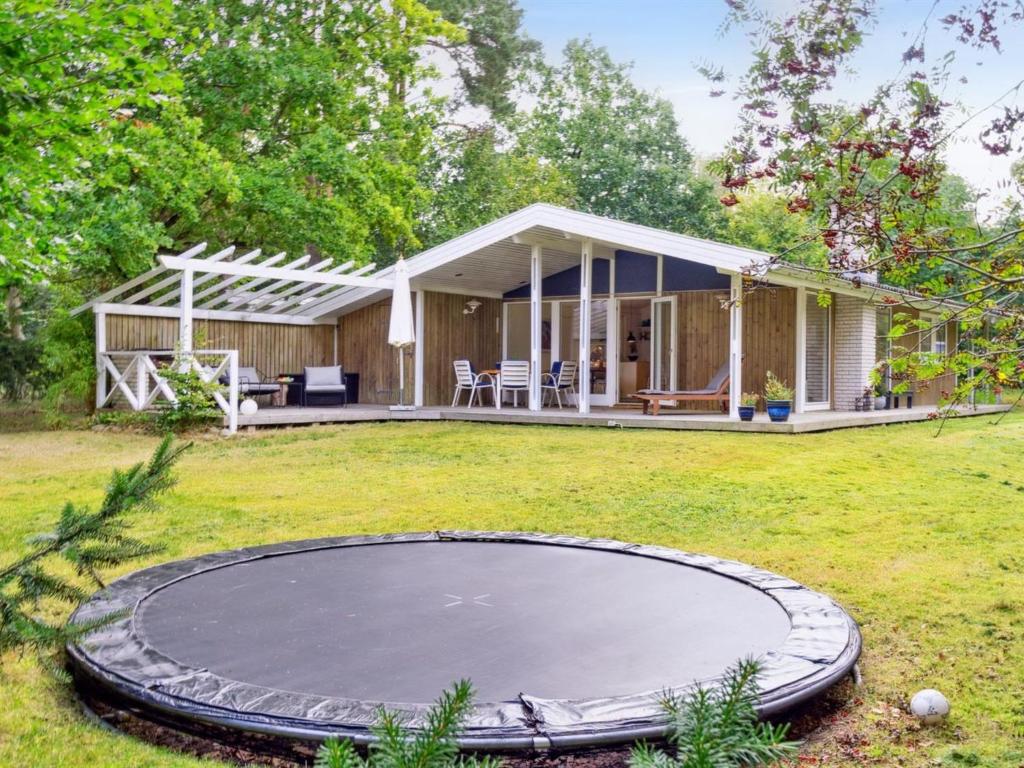 a house with a trampoline in the yard at Holiday Home Arto - 1-2km from the sea by Interhome in Vig