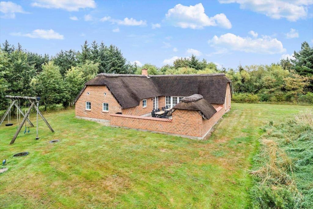 an old house with a thatched roof in a field at 51401-Ulfborg-Sdr-Fjandvej-46 in Fjand Gårde