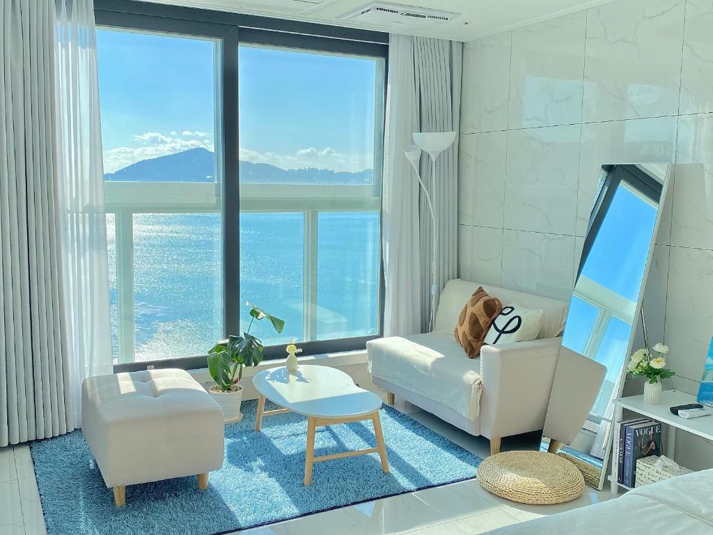 a living room with a couch and a chair at 광안리 T-OCEAN House in Kwangan-dong