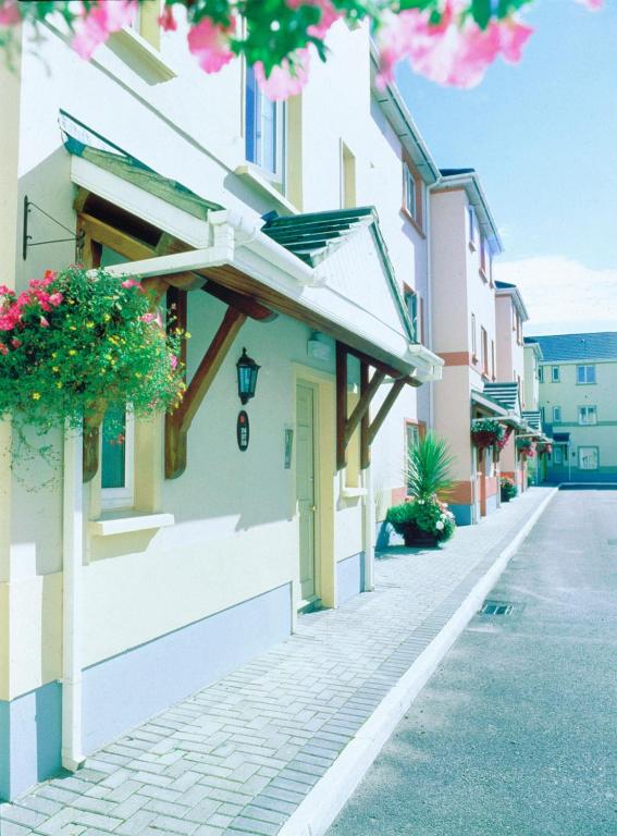 a street in a town with buildings and flowers at Tralee Town Centre Apartments in Tralee