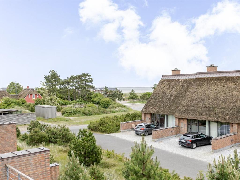 two cars parked in a parking lot next to a building at Apartment Øgoti - 500m from the sea by Interhome in Sønderby