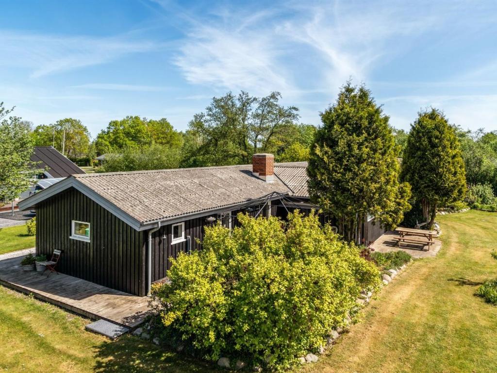 an image of a black house with a yard at Holiday Home Meindor - 240m to the fjord by Interhome in Storvorde