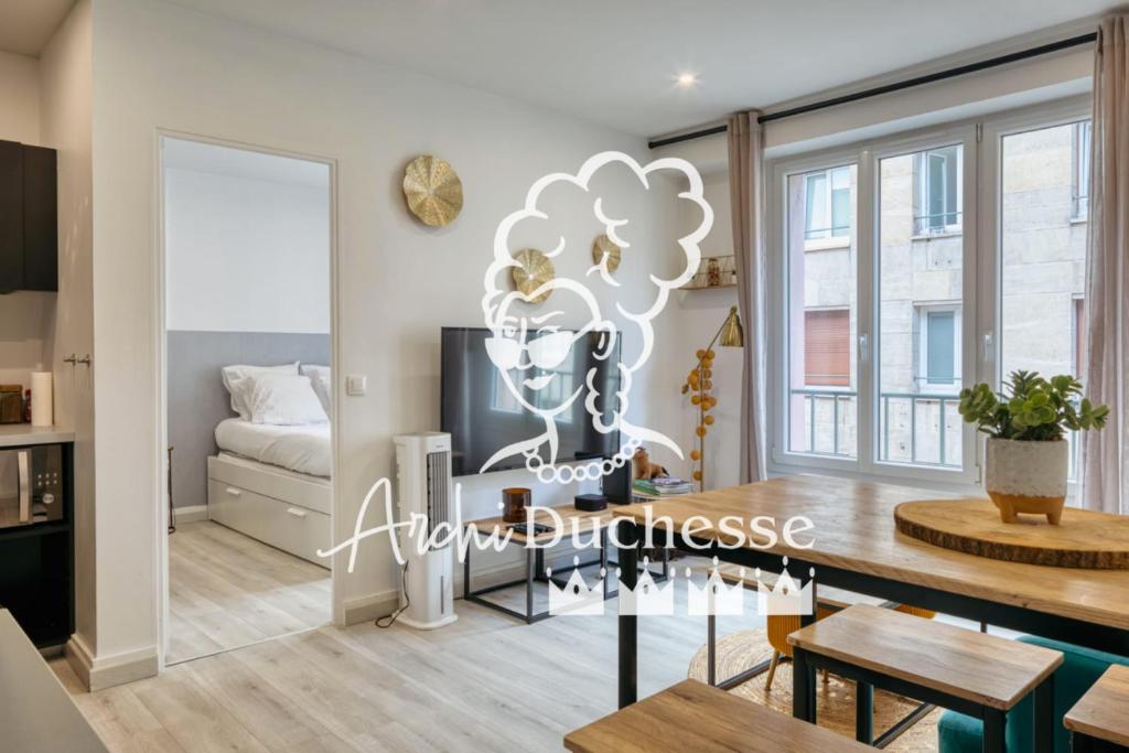 a living room with a dining room table and a bed at Frau - 2 suites avec ascenseur à côte de la Cathédrale de Rouen ! in Rouen