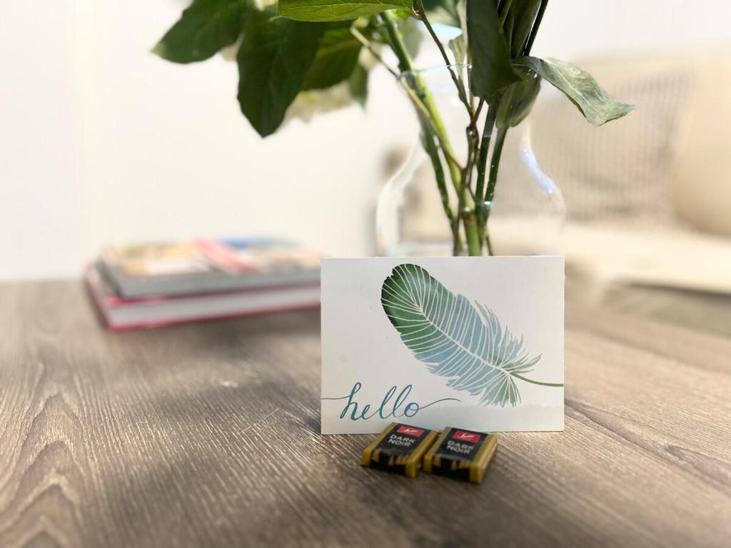 a white card with a vase with a plant at Cozy Guest Suite Walk to Ocean & Shops in West Vancouver