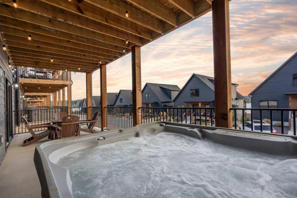 a hot tub on the deck of a house at Pineapple Shores - Stay for 14 in Hollister