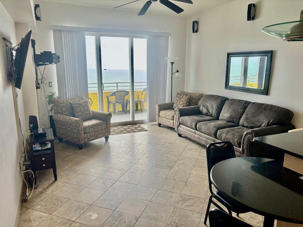 a living room with a couch and a table at Ocean Walk Resort Magnificent Ocean Front View in Daytona Beach