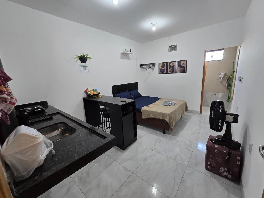 een woonkamer met een bank en een bed in een kamer bij Flat completo 14 minutos do centro do Buriti Shopping in Aparecida de Goiania