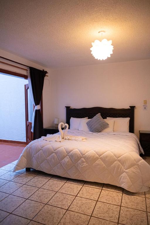 Postel nebo postele na pokoji v ubytování Hotel Casa Linda