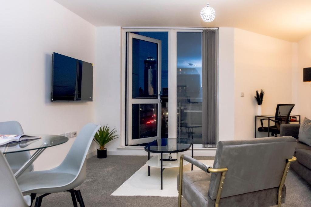 a living room with a table and chairs at CENTRAL Luxury 2BR Apartment Manchester in Manchester