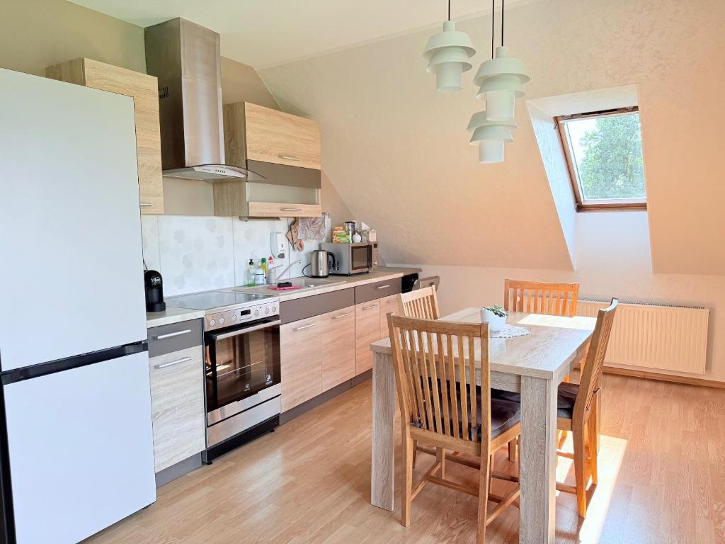 a kitchen with a table and chairs and a refrigerator at Anny's Downtown Apartment in Valga