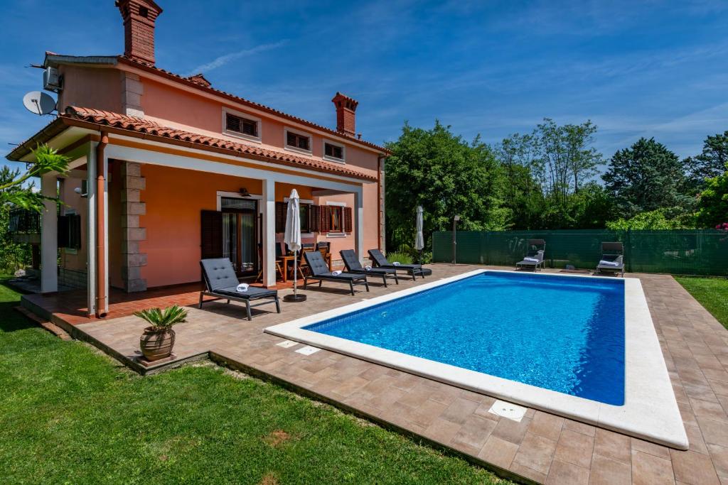 a swimming pool in the yard of a house at Villa Ornela, summer and sun, ideal for families and pets! in Santalezi