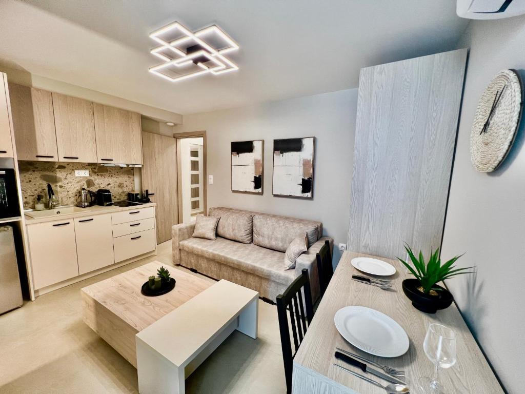 a kitchen and living room with a table and a couch at Douloudis Luxury Apartment in Alexandroupoli