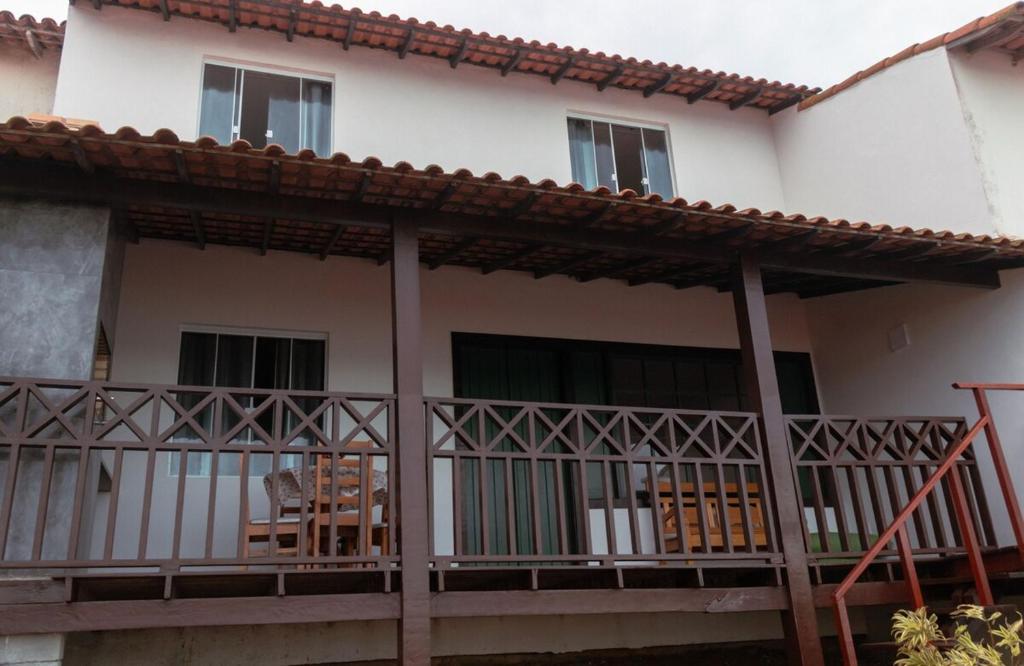 a house with a balcony with chairs on it at Casa em Búzios com vista espetacular in Búzios