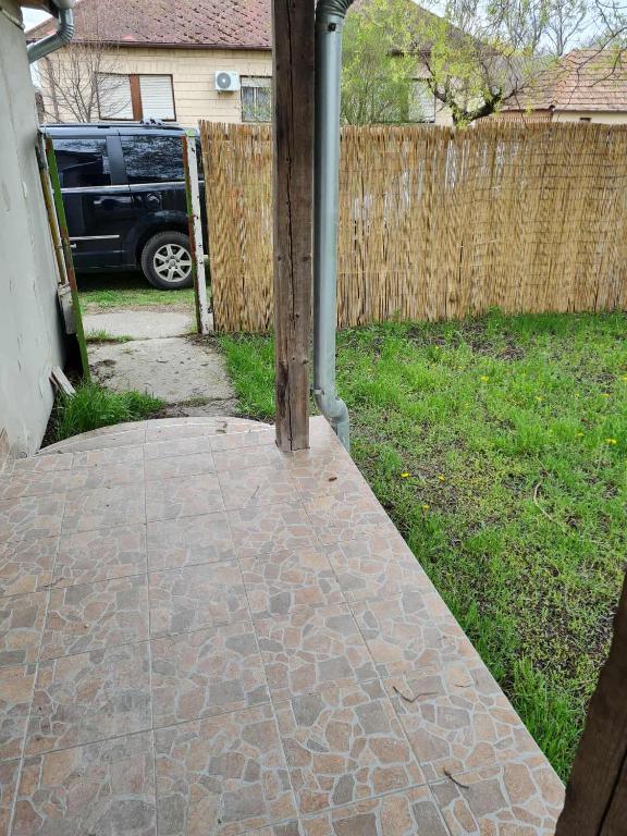 a brick walkway in a yard with a fence at Haus Ursula in Orgovány