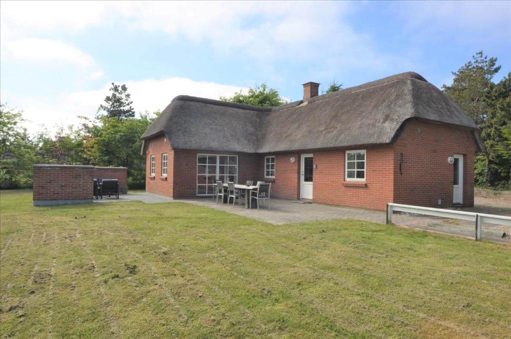 a red brick house with a thatched roof at 20132-Ulfborg-Tyttebaervej-19 in Ulfborg