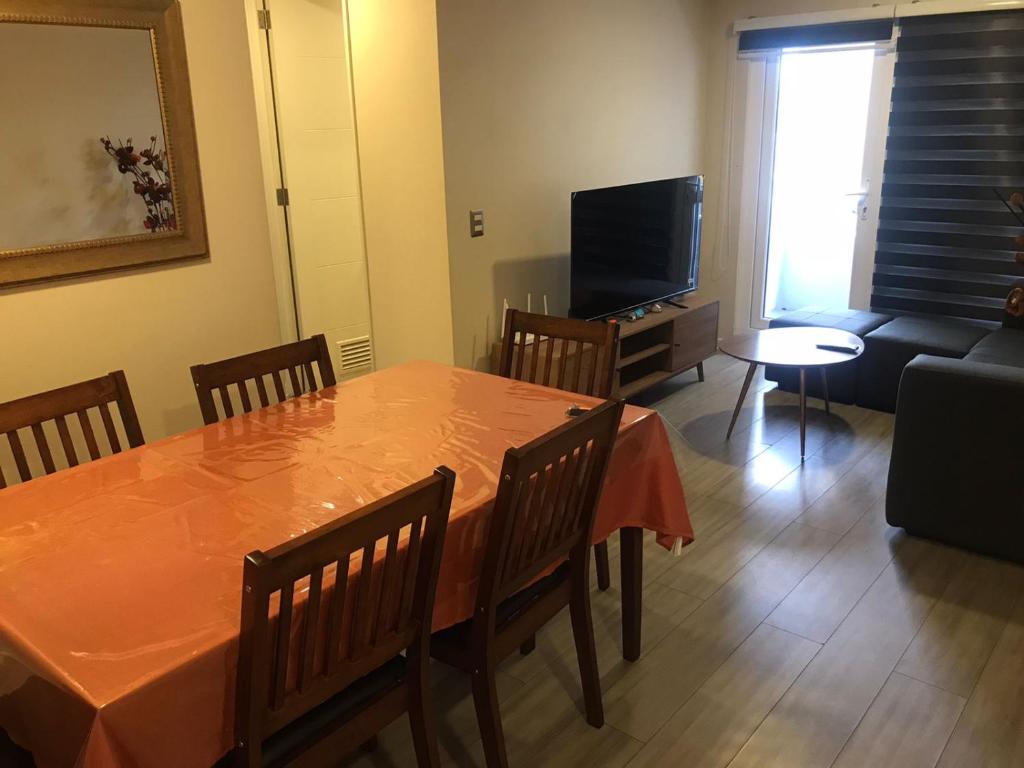 a living room with a table and a couch at Lagos Temuco in Temuco