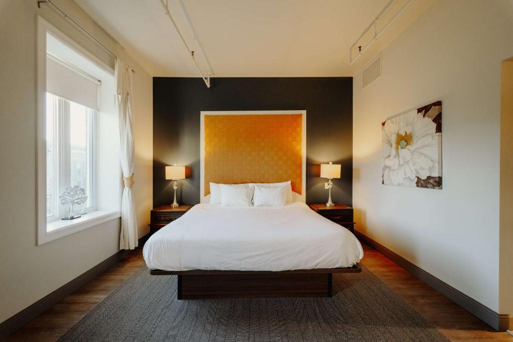 a bedroom with a white bed and two lamps at Mercer Hotel Downtown; BW Premier Collection in Stratford